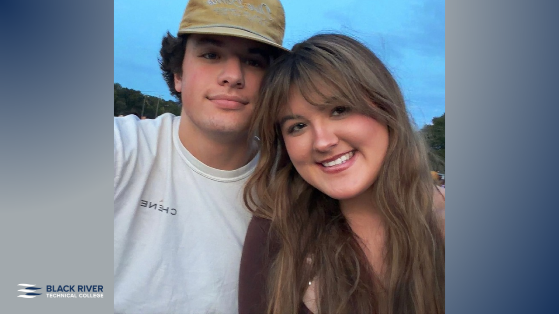 A young man in a tan cap and a young woman with long wavy hair smile together in a close-up outdoor photo at dusk, with Black River Technical College branding.